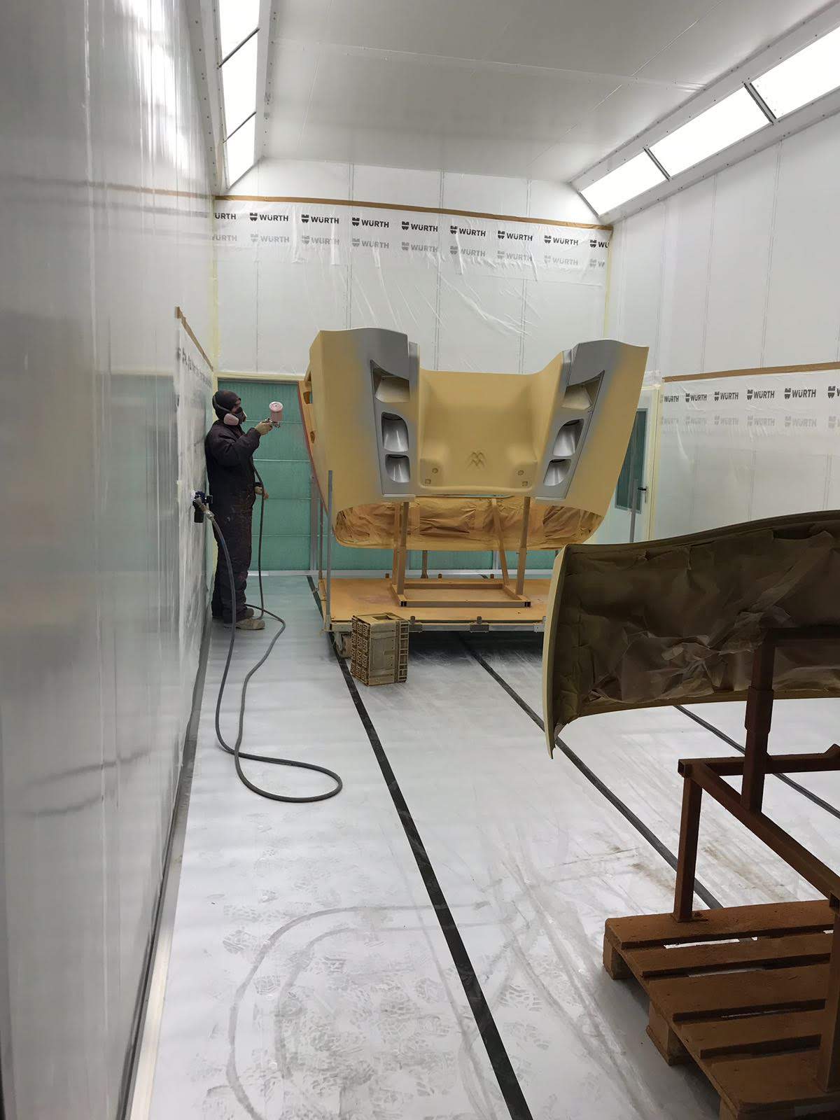 Vehicle front and roof segment in the spray booth during coating