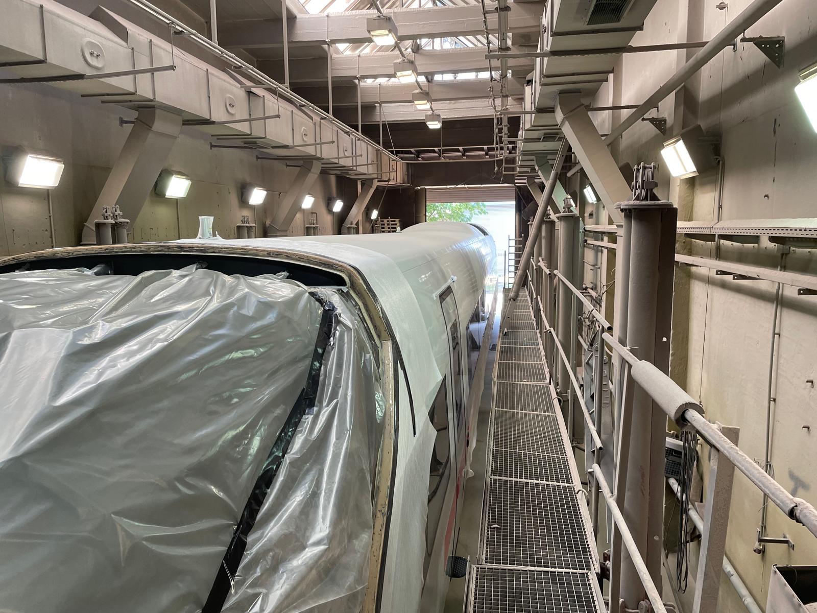 Complete masked ICE train in the large paint hall alongside the working platform
